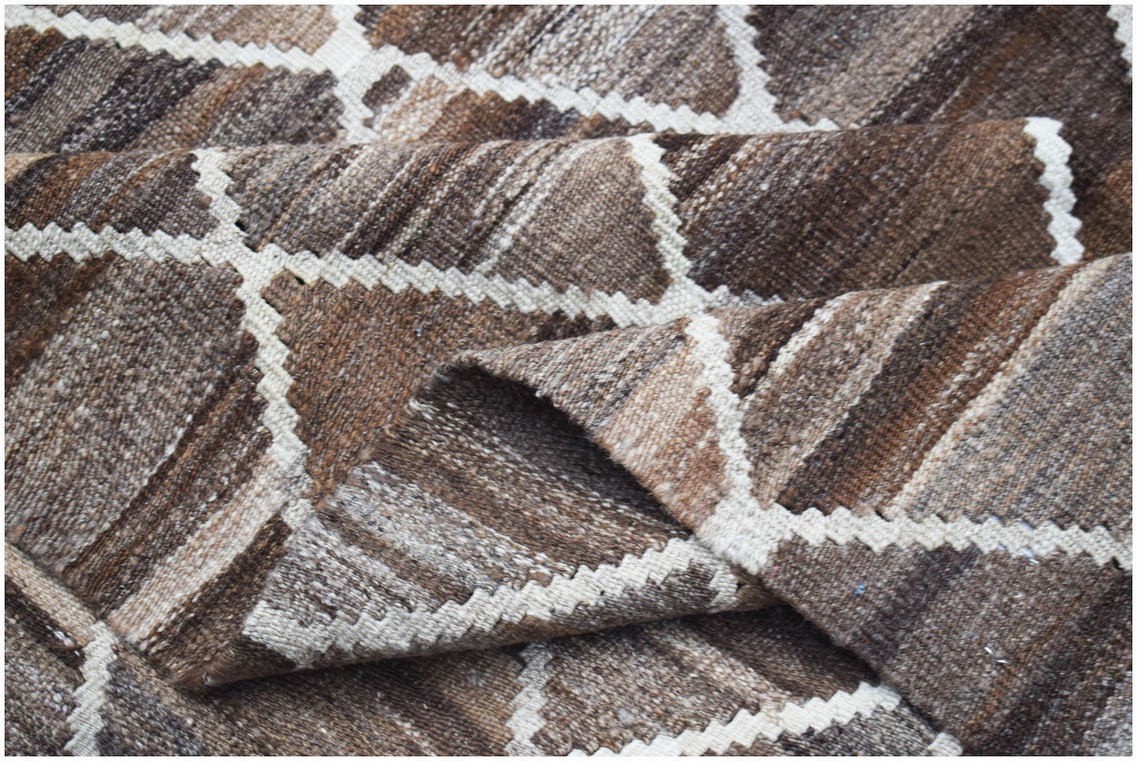 Handwoven Afghan Maimana kilim featuring a brown and cream geometric diamond pattern.