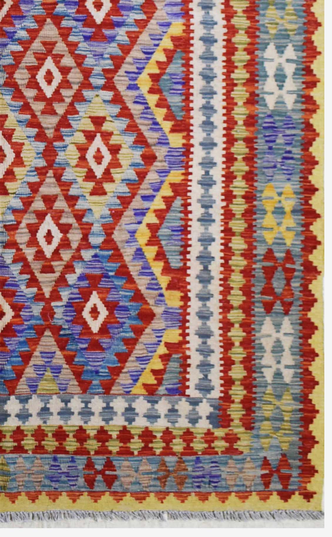 Handmade Afghan Maimana kilim rug featuring a vibrant geometric diamond pattern in wool.