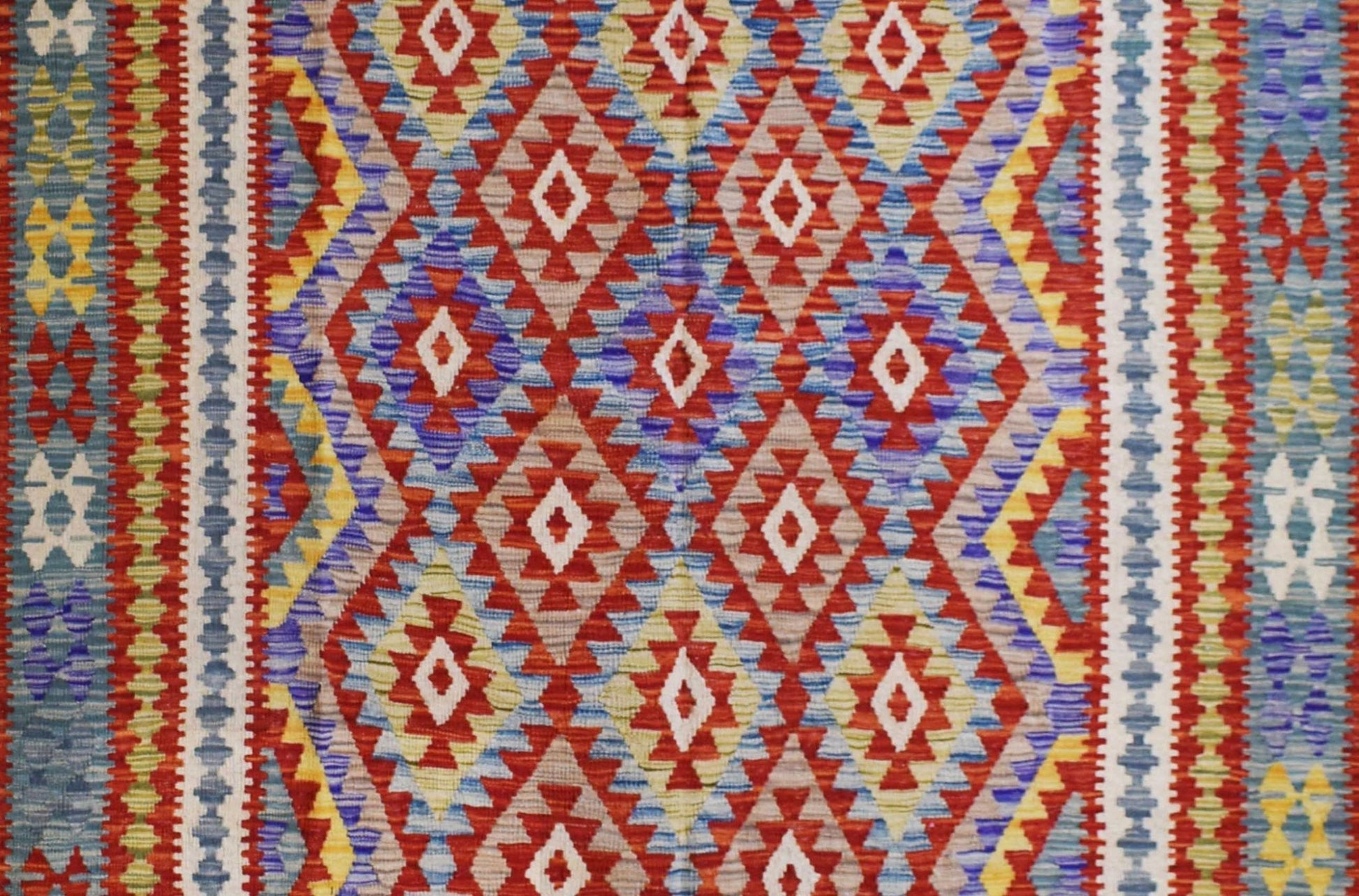 Handmade Afghan Maimana kilim rug featuring a vibrant geometric diamond pattern in wool.