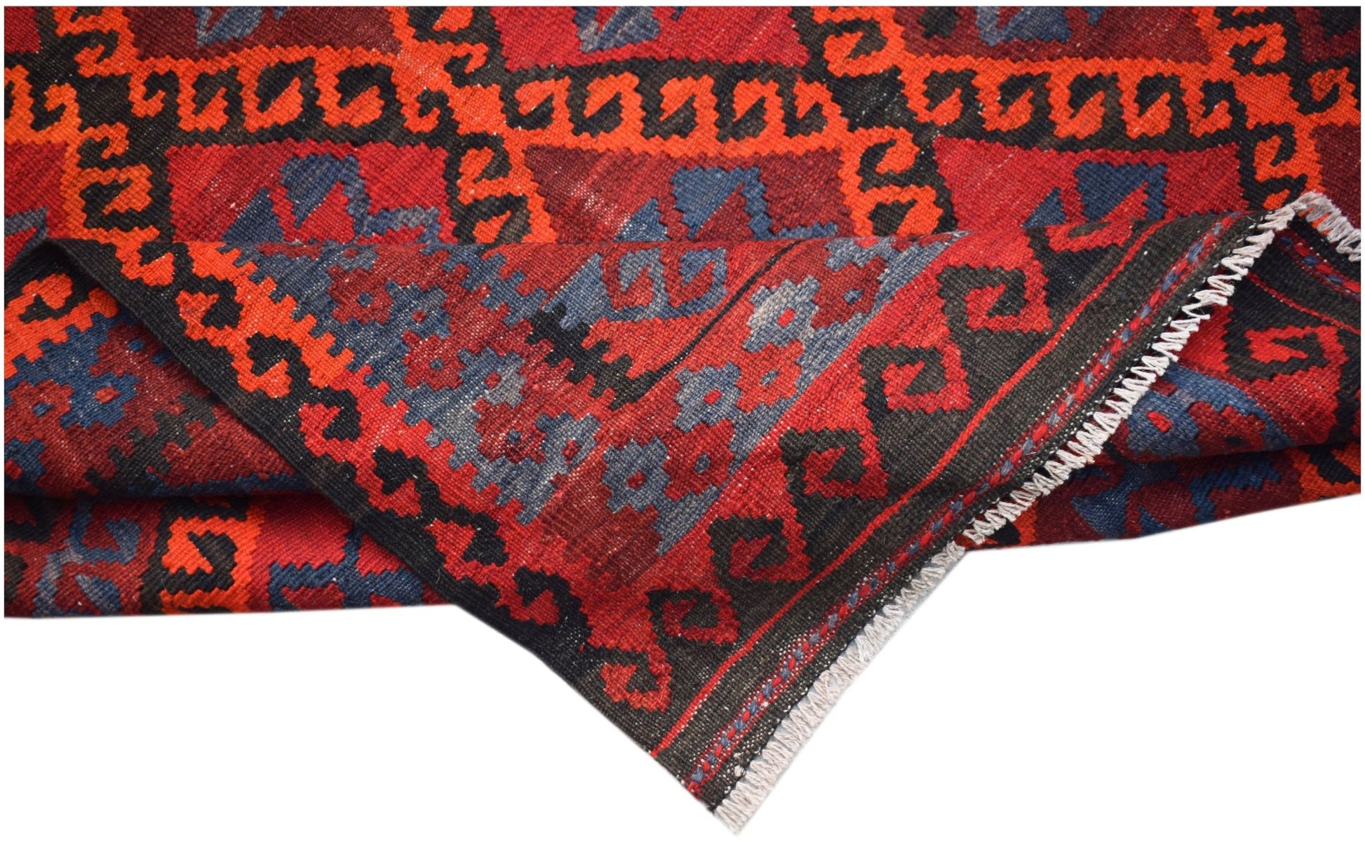 A handmade Afghan Maimana kilim featuring a geometric pattern in red, black, and blue wool.