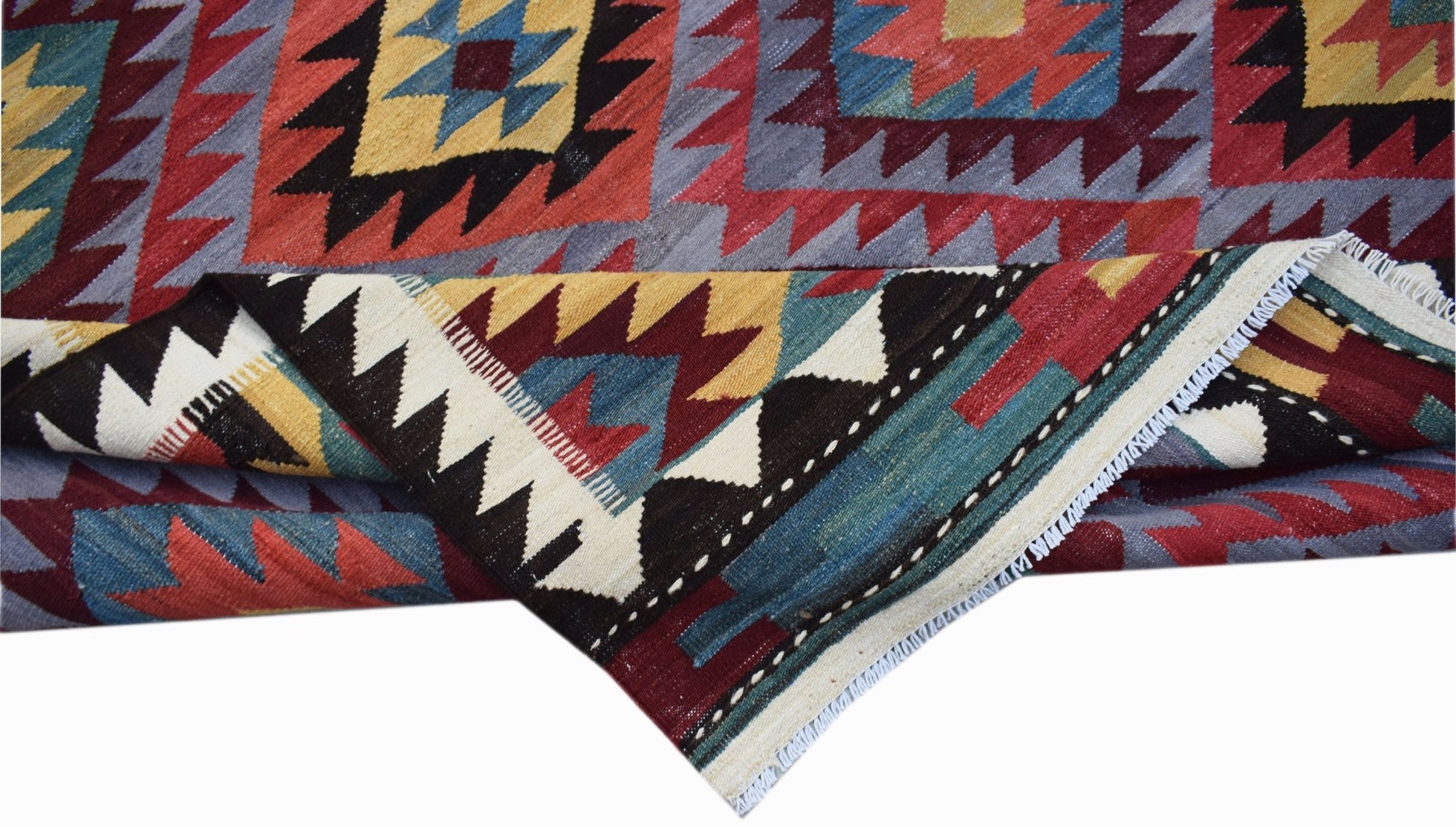 A handmade Afghan Maimana kilim rug featuring a geometric pattern in red, blue, and yellow wool.