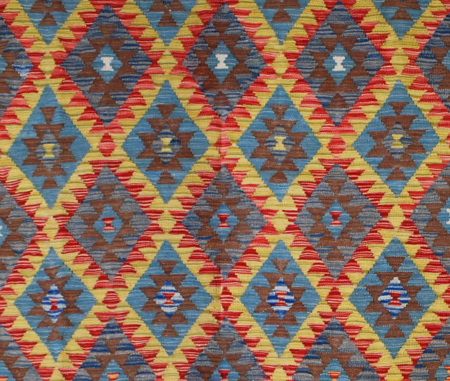 Handmade Afghan Maimana kilim rug featuring a vibrant geometric diamond pattern in wool.