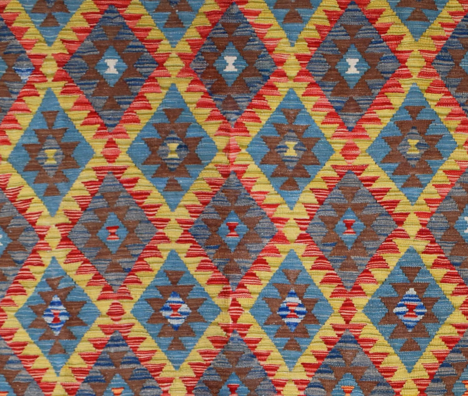 Handmade Afghan Maimana kilim rug featuring a vibrant geometric diamond pattern in wool.