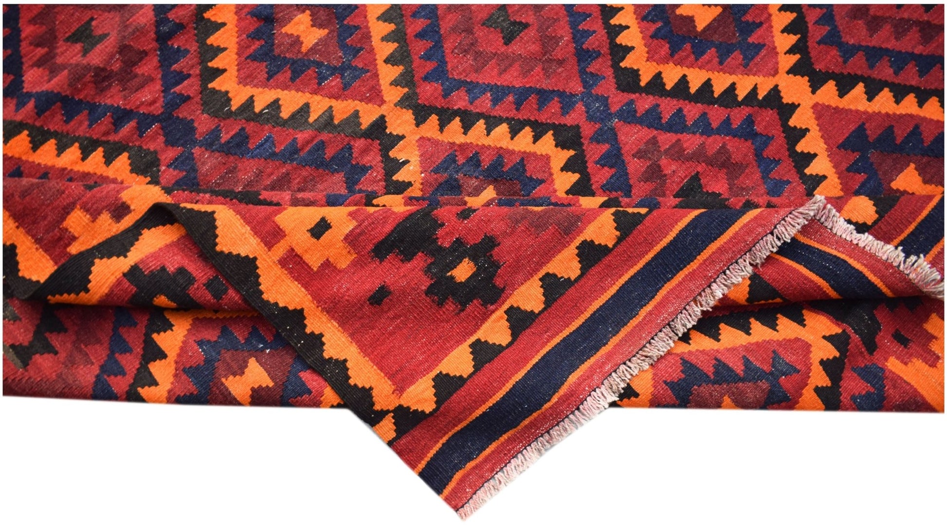 A handmade Afghan Maimana kilim featuring a geometric pattern in red, orange, and dark blue.