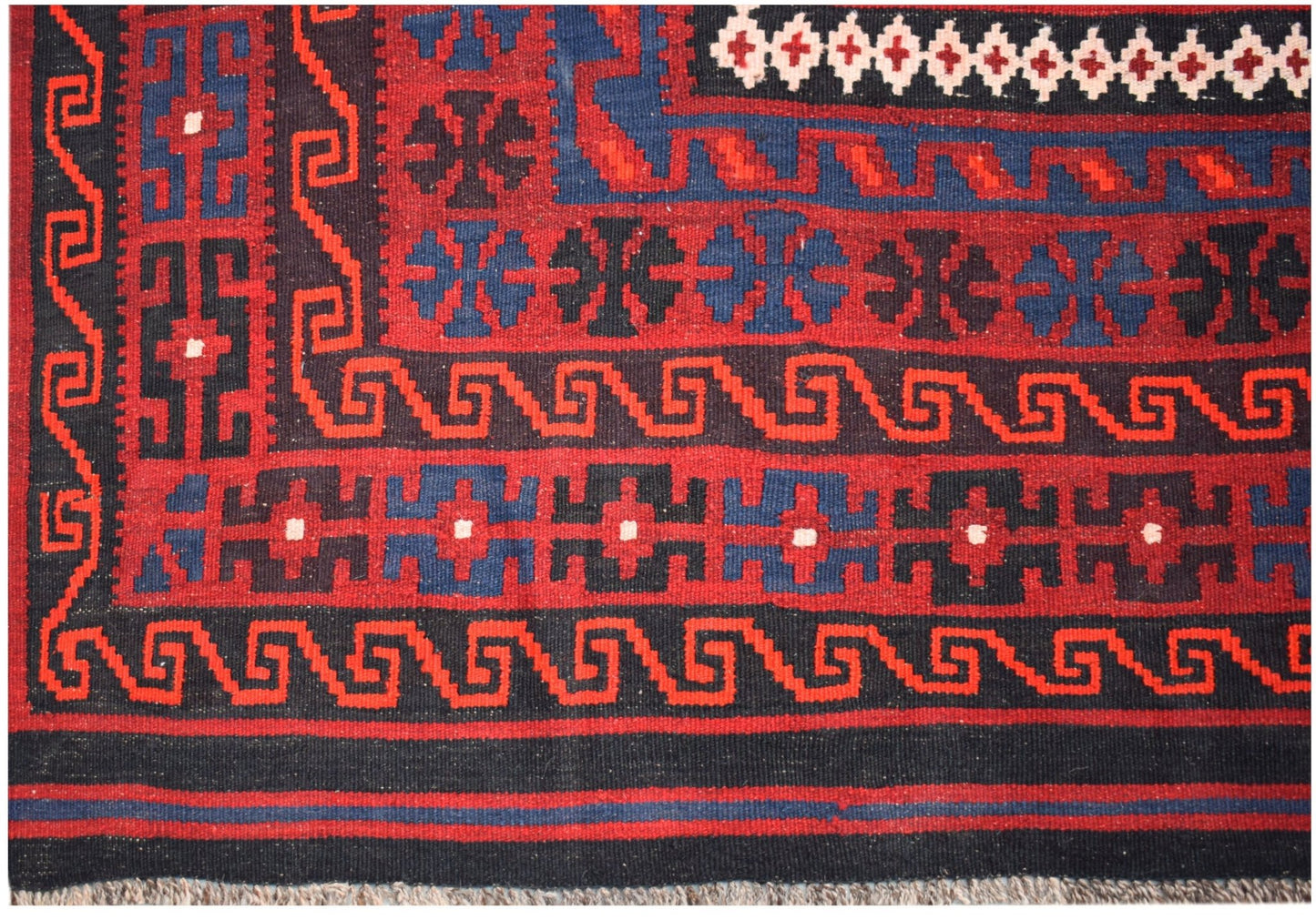 Handwoven Afghan Maimana kilim featuring geometric patterns in red, blue, and black wool.