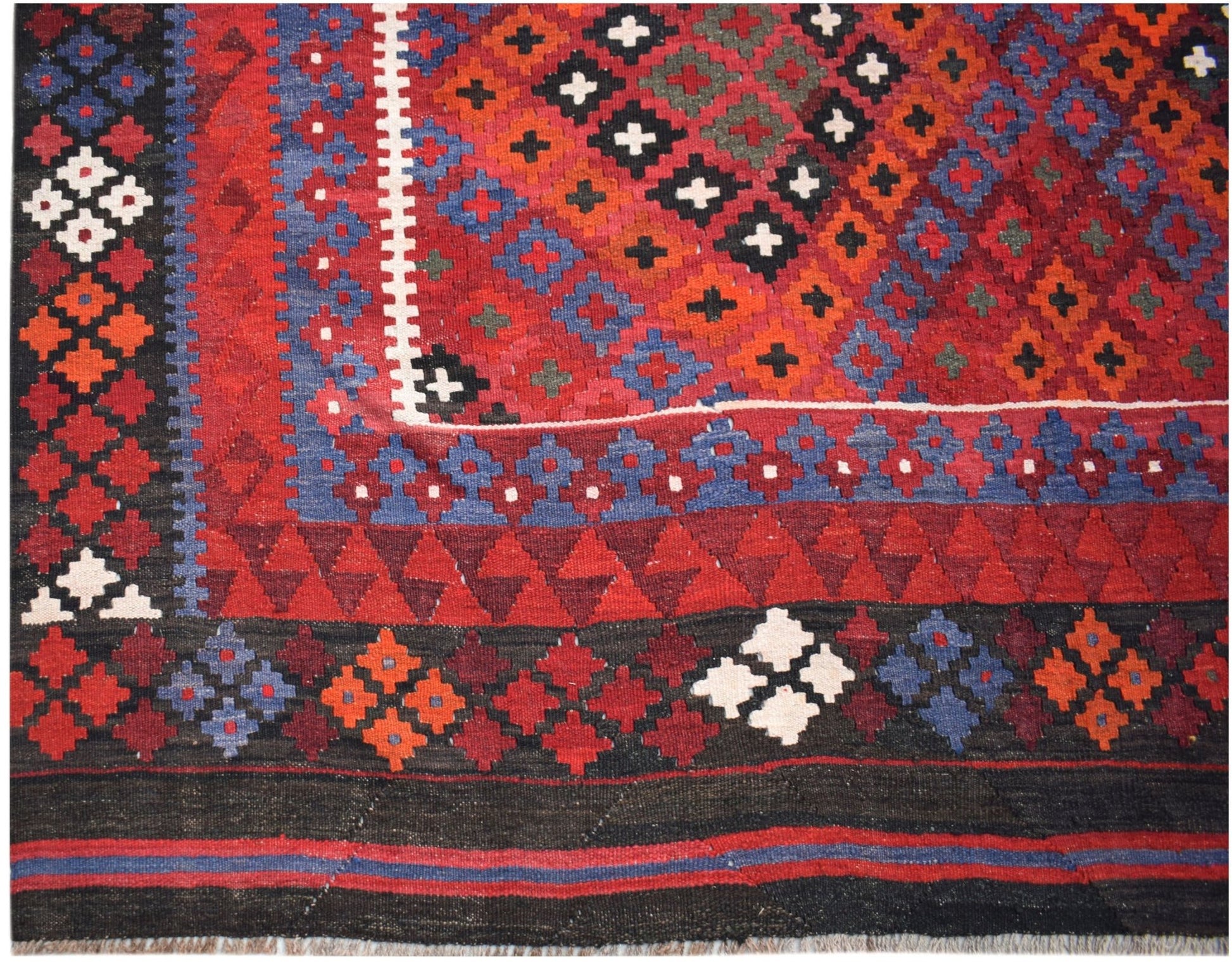 Handwoven Afghan Maimana kilim featuring a geometric pattern in red, blue, and black wool.