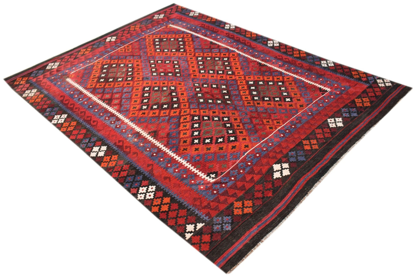 A handmade Afghan Maimana kilim rug featuring a geometric diamond pattern in red, blue, and orange.