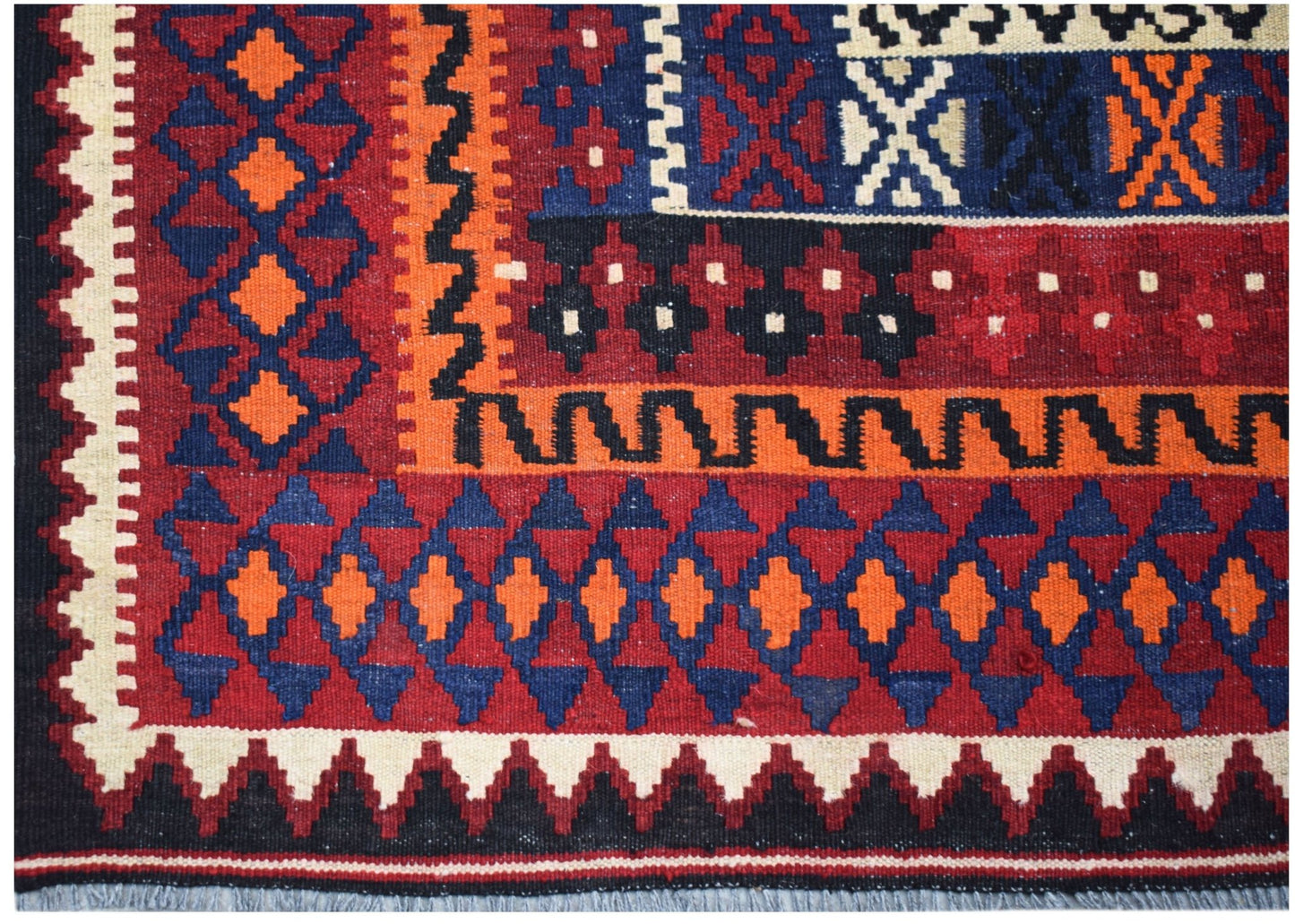 Handwoven Afghan Maimana kilim featuring a geometric pattern in red, blue, orange, and cream.
