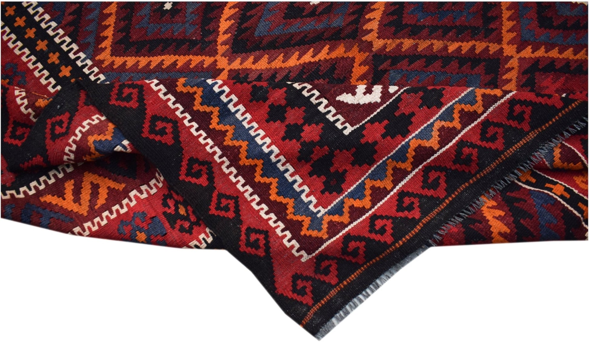 A handwoven Afghan Maimana kilim rug featuring geometric patterns in red, black, orange, and blue.