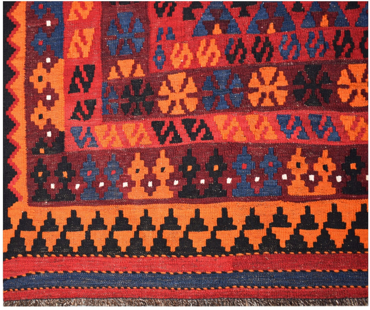Handwoven Afghan Maimana kilim featuring geometric patterns in red, orange, blue, and black wool.