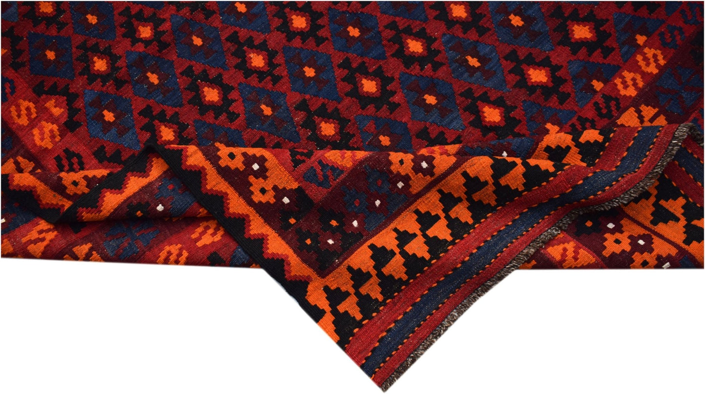Handwoven Afghan Maimana kilim featuring a geometric pattern in red, blue, and orange wool.