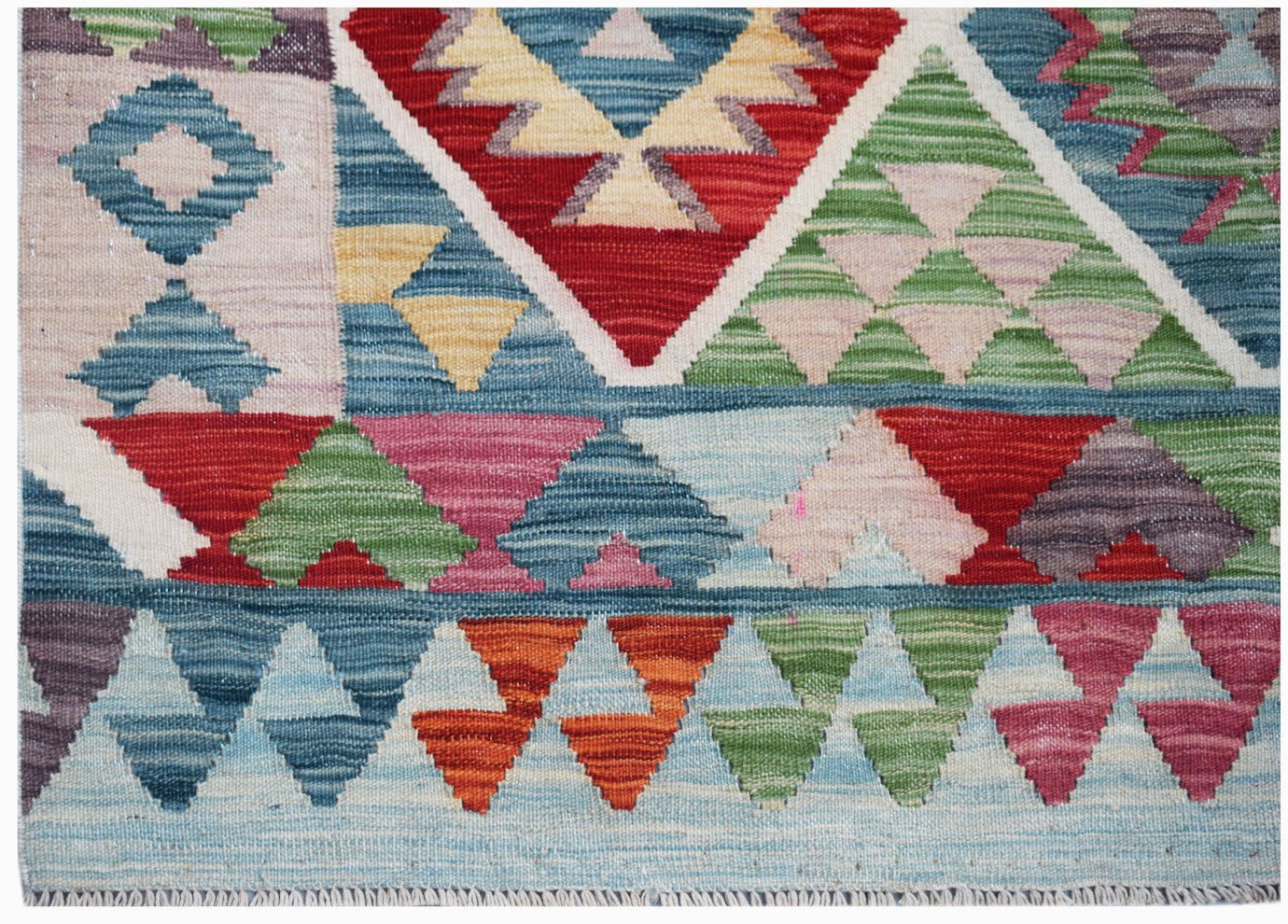 Handwoven Afghan Maimana kilim featuring a vibrant geometric pattern in wool.