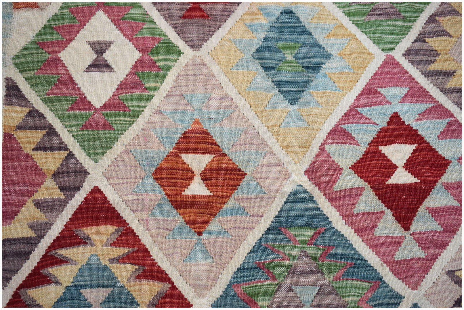 Handwoven Afghan Maimana kilim featuring a colorful geometric diamond pattern in wool.