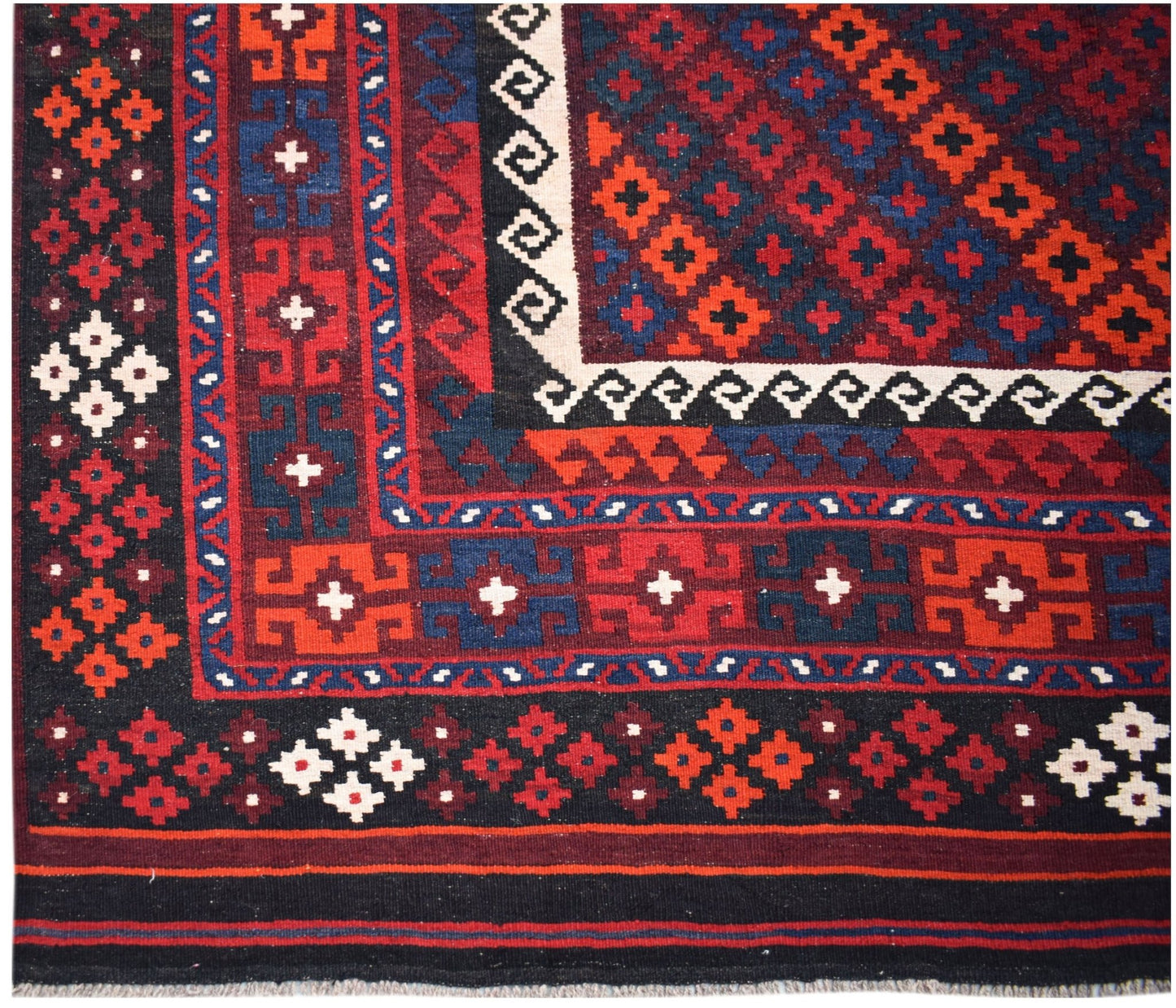 Handwoven Afghan Maimana kilim featuring a geometric pattern in red, blue, and black wool.