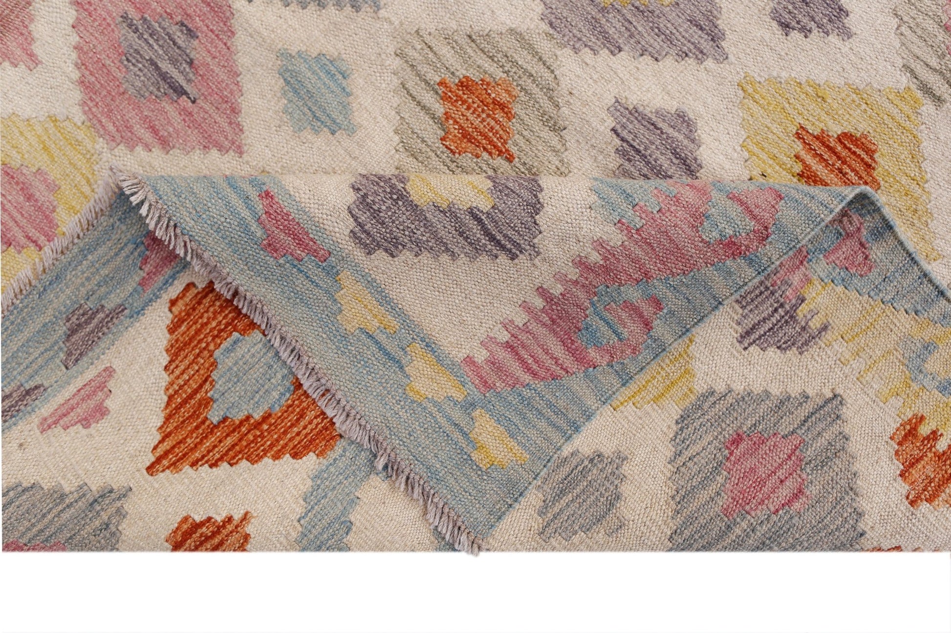 A handmade Afghan Maimana kilim rug featuring a geometric pattern in colorful wool.