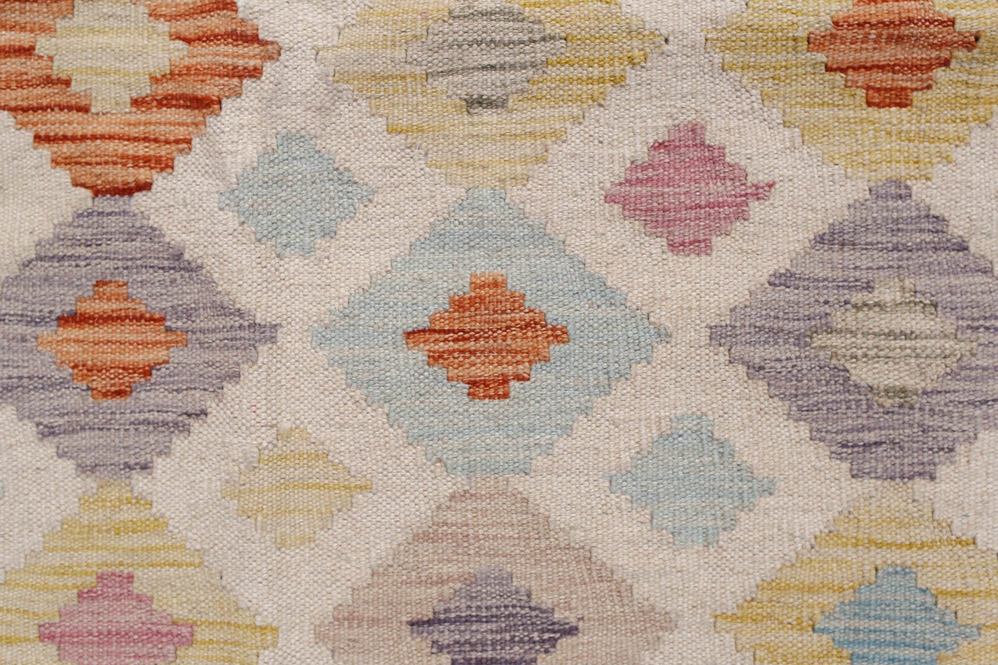 Handwoven Afghan Maimana kilim featuring a geometric diamond pattern in soft multicolored hues.