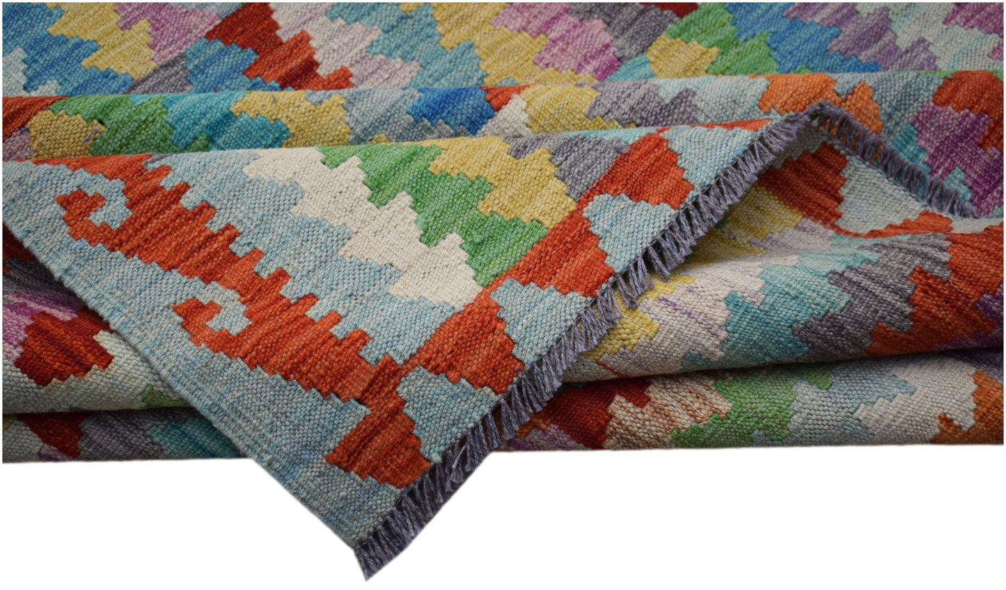 Handwoven Afghan Maimana kilim featuring a colorful geometric pattern in a flatweave wool texture.