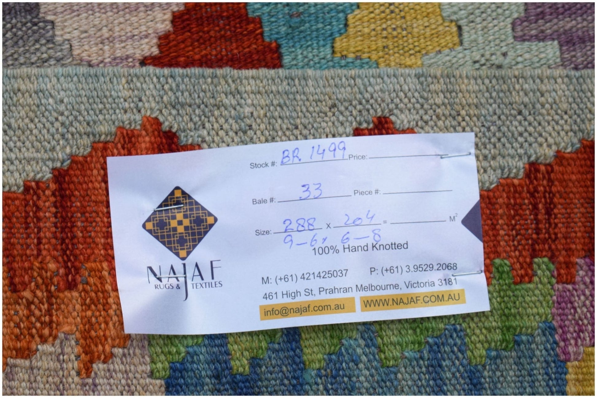 An Afghan Maimana Kilim rug featuring a vibrant geometric pattern in wool.