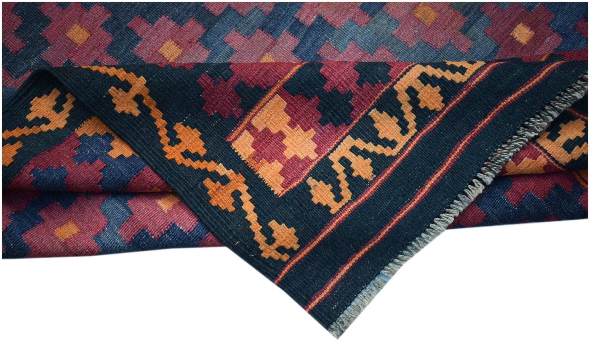 A handmade Afghan Maimana kilim featuring a geometric pattern in blue, red, and orange wool.