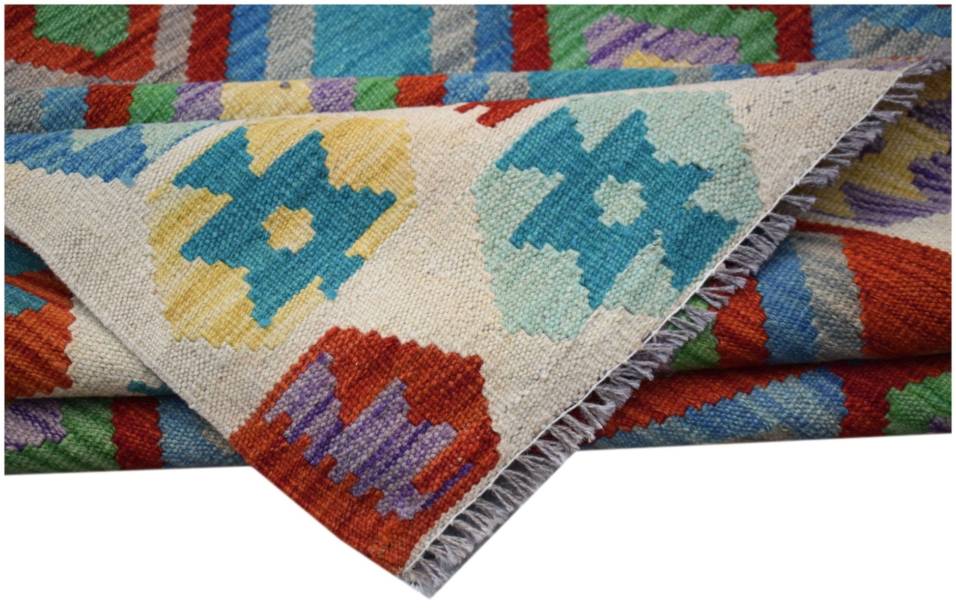 A handwoven Afghan Maimana kilim rug featuring a geometric pattern in vibrant multicolored wool.