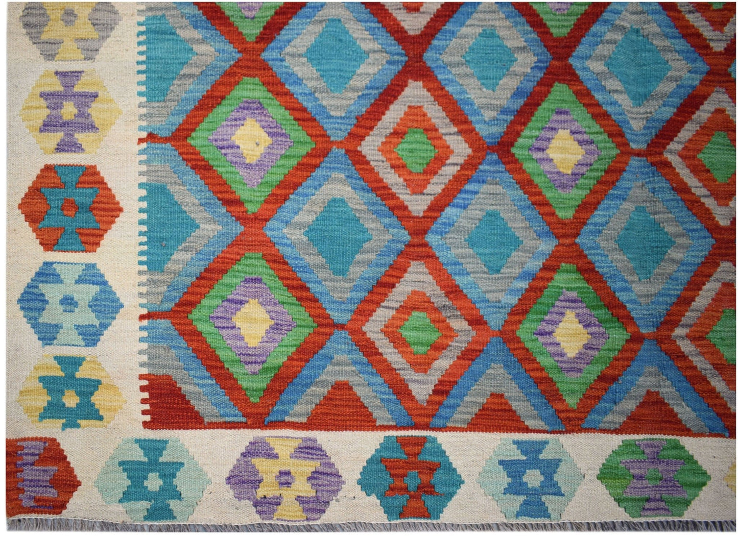 Handwoven Afghan Maimana Kilim featuring a vibrant geometric diamond pattern in wool.