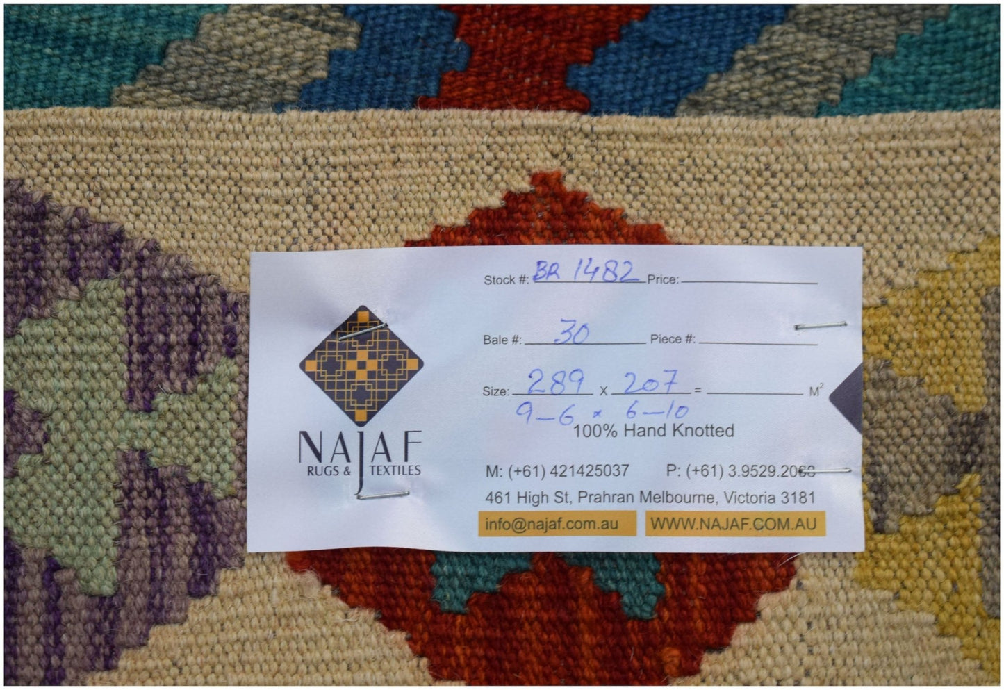 A handwoven Afghan Maimana Kilim featuring a colorful geometric pattern on a cream background.