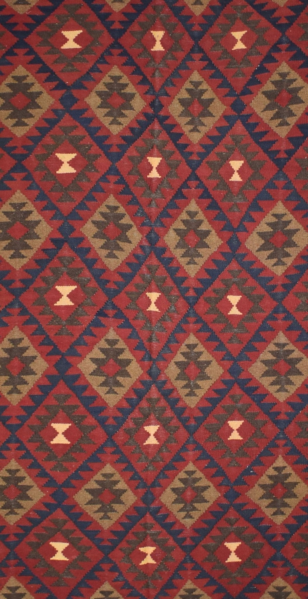 Handmade Afghan Maimana kilim rug featuring a repeating geometric diamond pattern in red and brown.