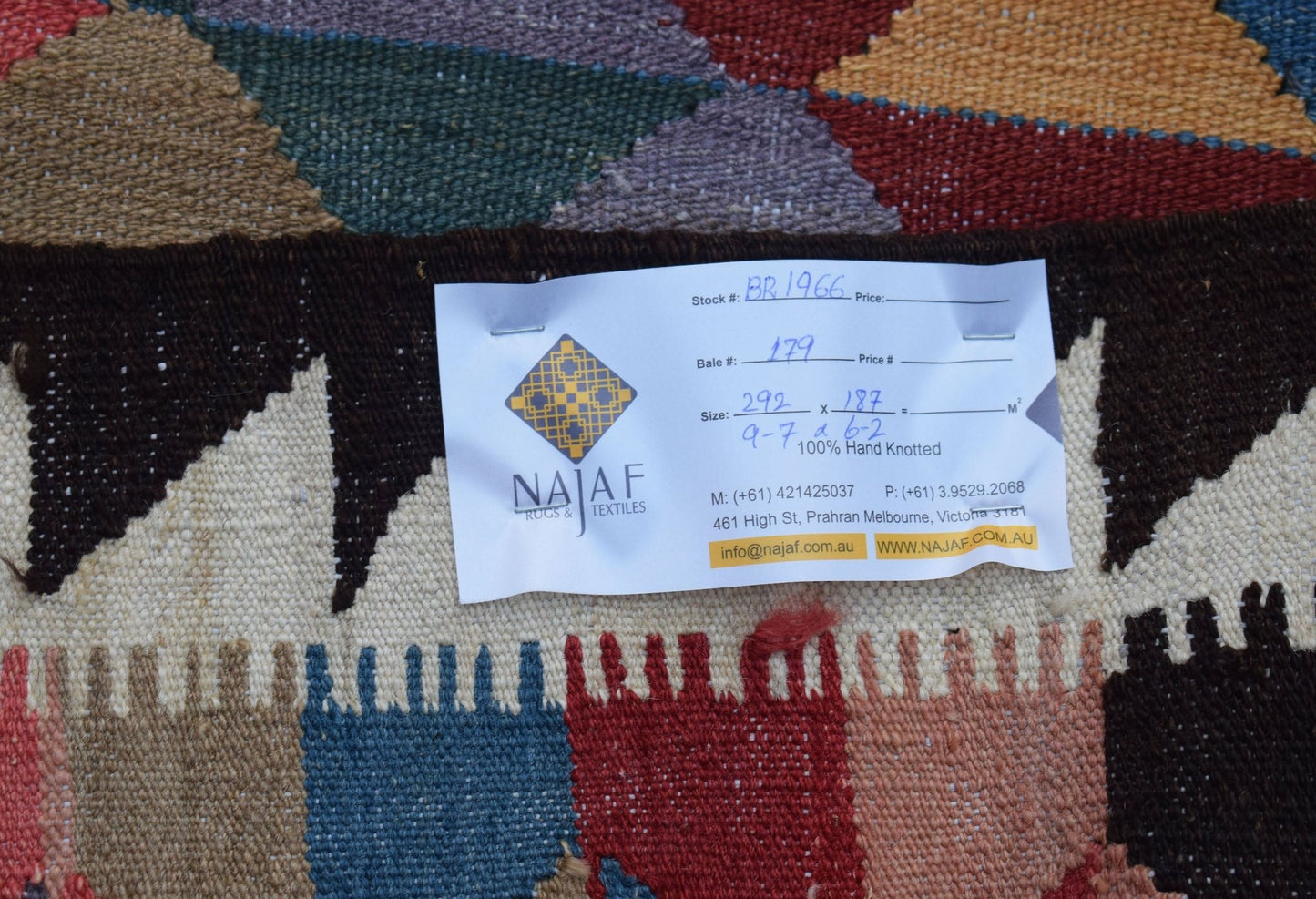 A handmade Afghan Maimana kilim featuring a colorful geometric pattern and flatweave texture.