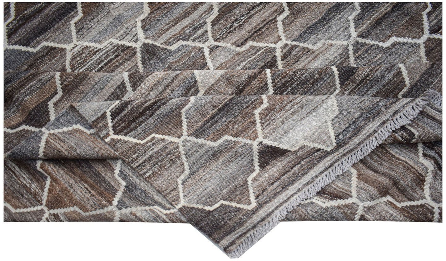 Handwoven Afghan Maimana kilim rug featuring a geometric pattern in shades of brown and grey.