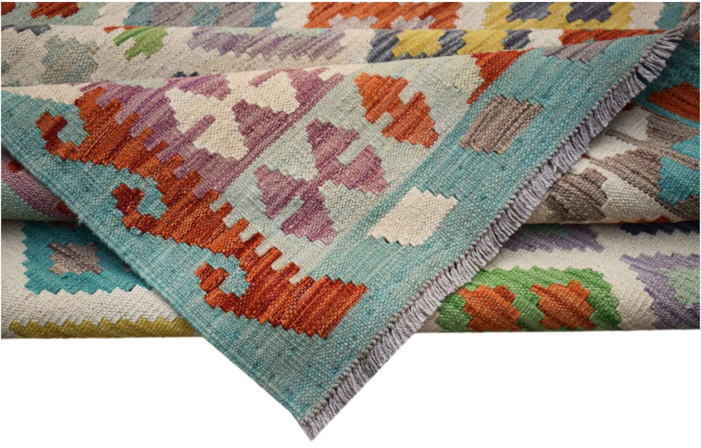 A handwoven Afghan Maimana kilim rug featuring geometric patterns in vibrant, multicolored wool.