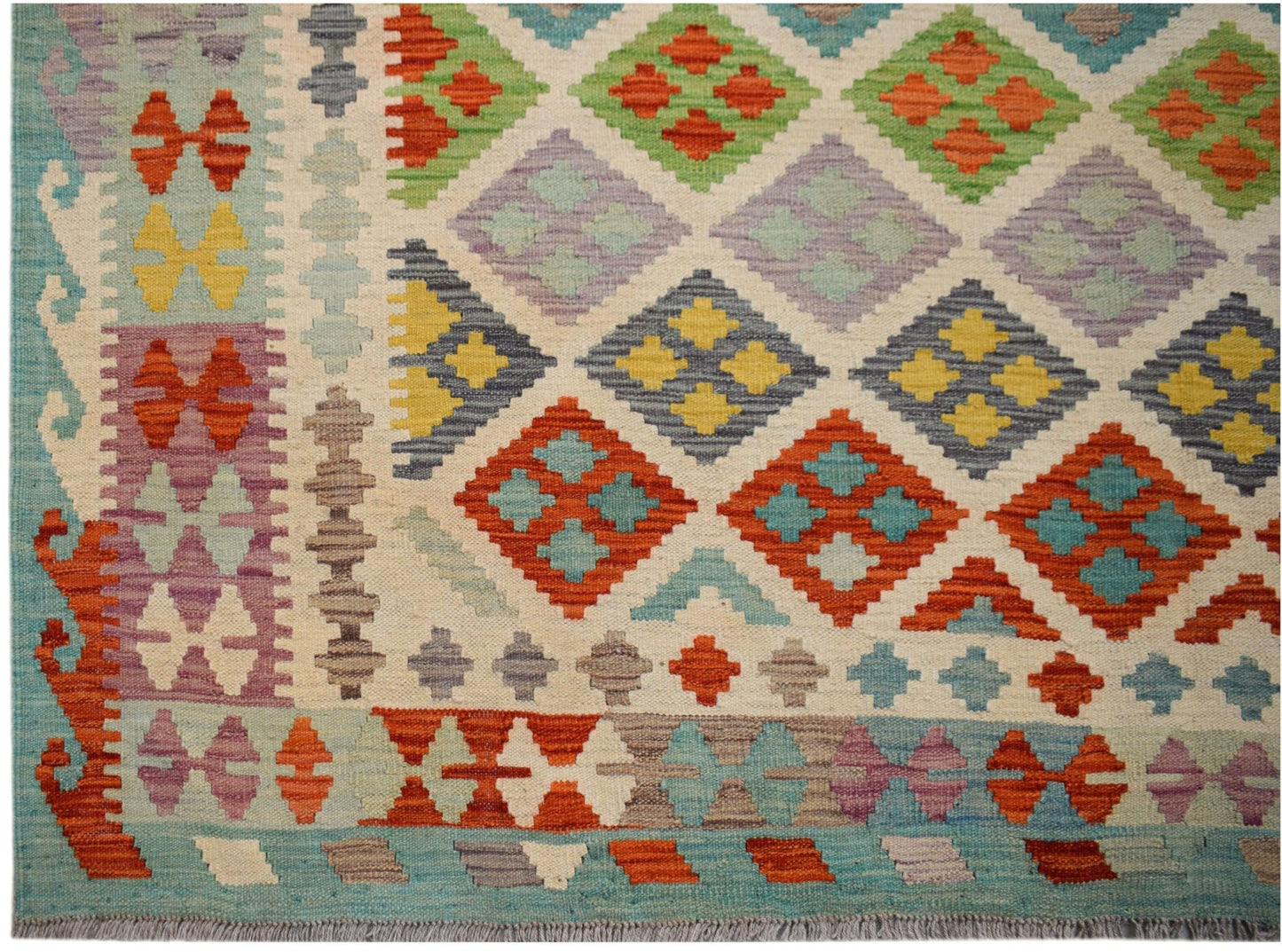 Handwoven Afghan Maimana kilim rug featuring a colorful geometric diamond pattern.
