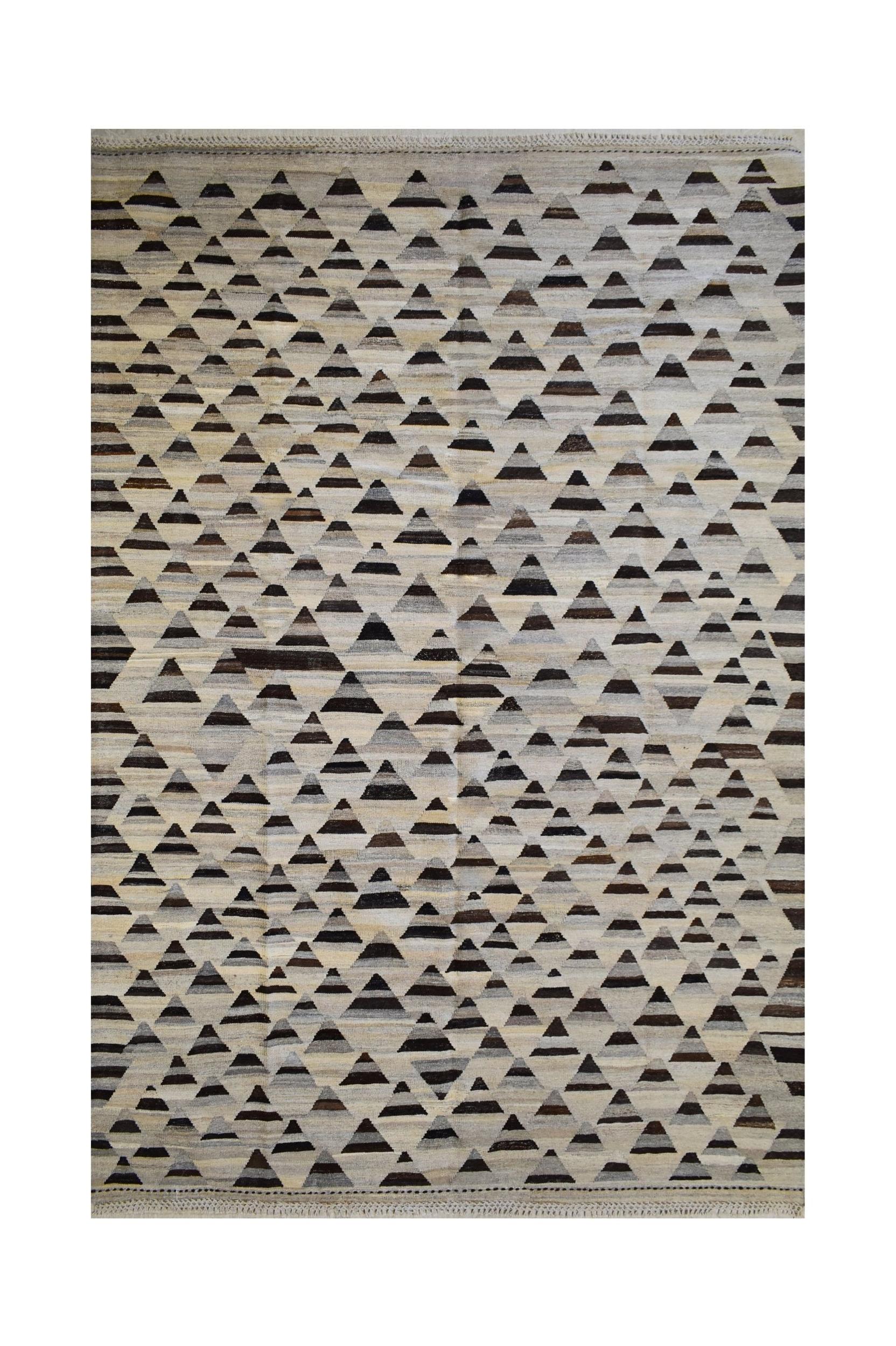 Handmade Afghan Maimana kilim rug featuring a repeating pattern of dark triangles on a neutral base.