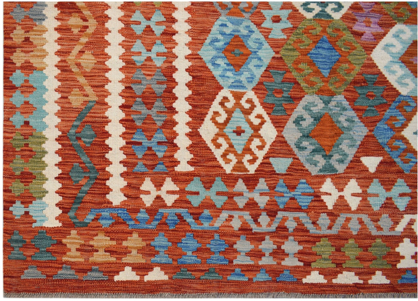 Handwoven Afghan Maimana kilim featuring a geometric pattern in vibrant orange and blue tones.