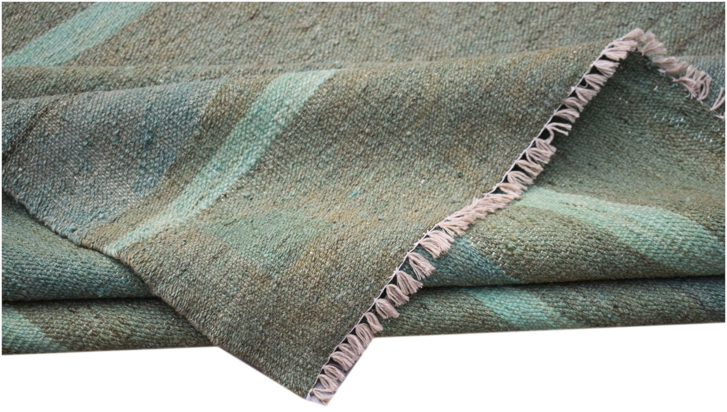 A handmade Afghan Maimana kilim rug featuring a flat-woven texture in shades of green.
