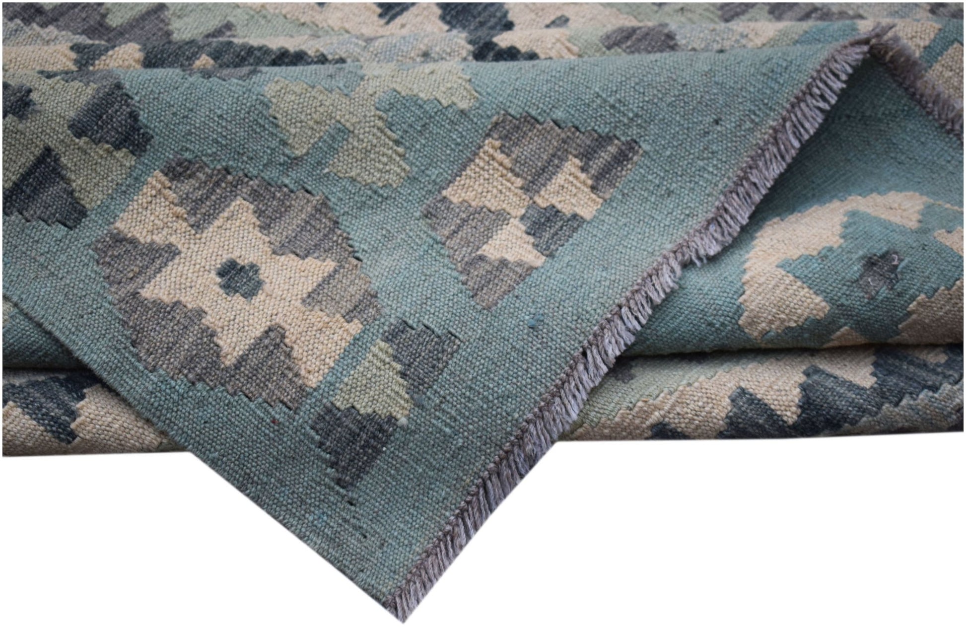 A handwoven Afghan Maimana kilim rug featuring a geometric pattern in blue, grey, and cream wool.