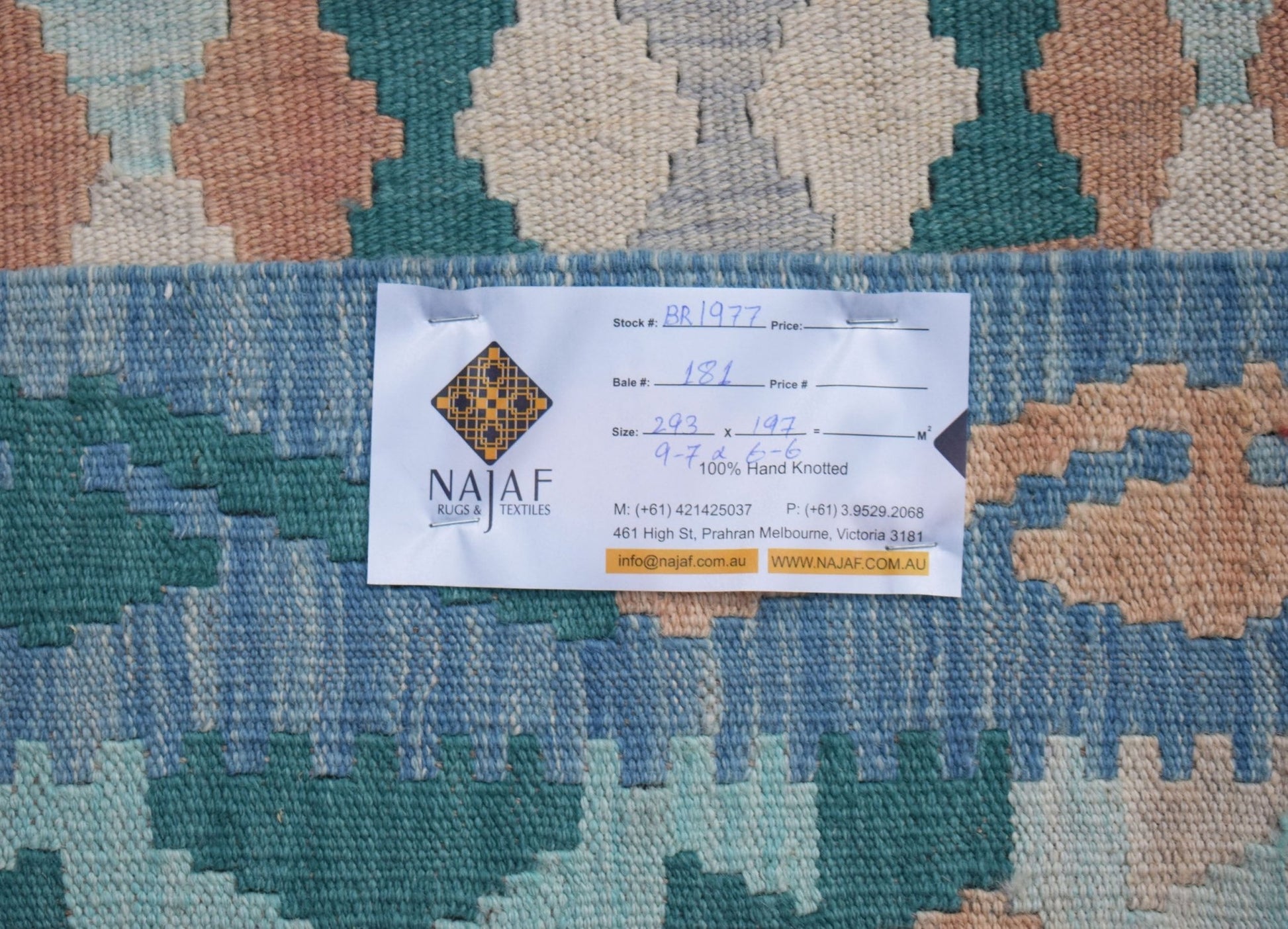 An Afghan Maimana Kilim rug featuring a geometric pattern in shades of blue, cream, and peach.