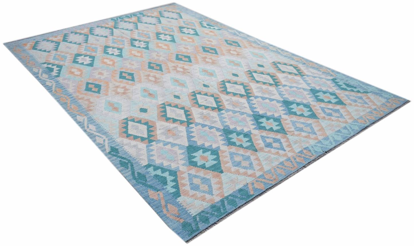 A handmade Afghan Maimana kilim rug featuring a geometric diamond pattern in blue and peach tones.