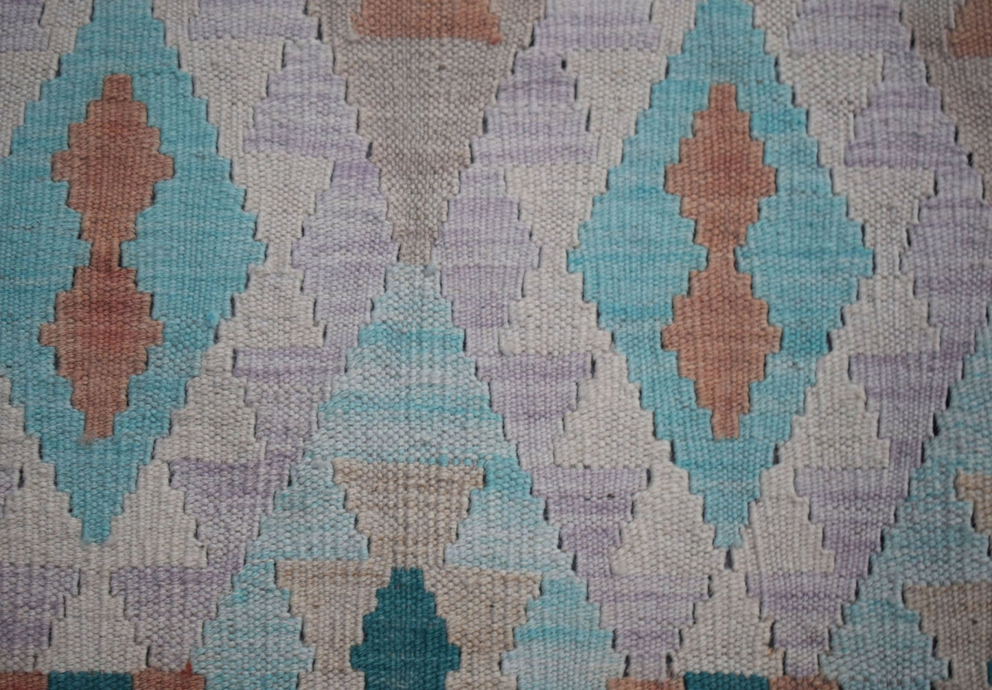 Handwoven Afghan Maimana kilim featuring a geometric diamond pattern in soft pastel tones.