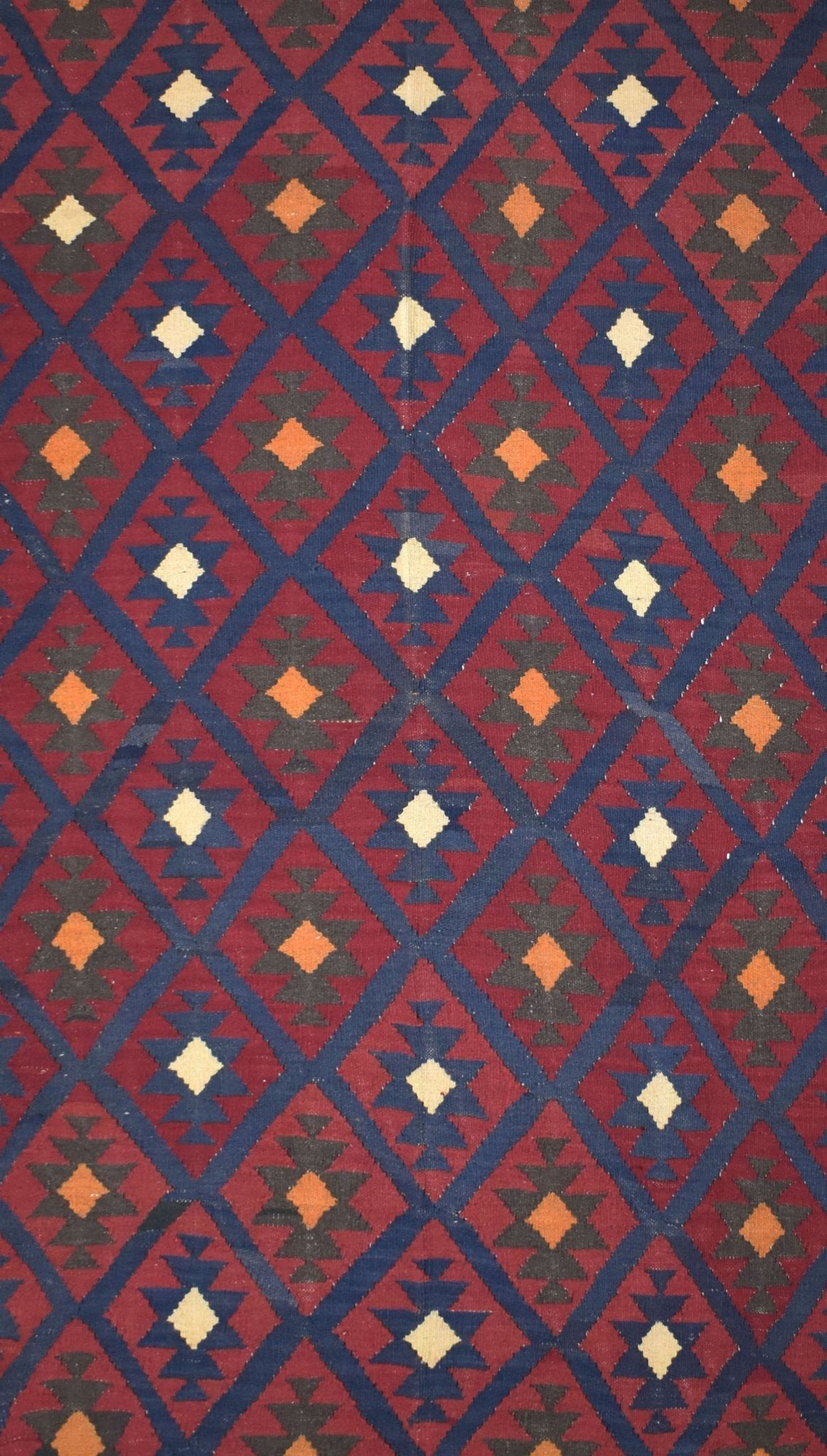 Handmade Afghan Maimana kilim rug featuring a repeating geometric diamond pattern in red and blue.