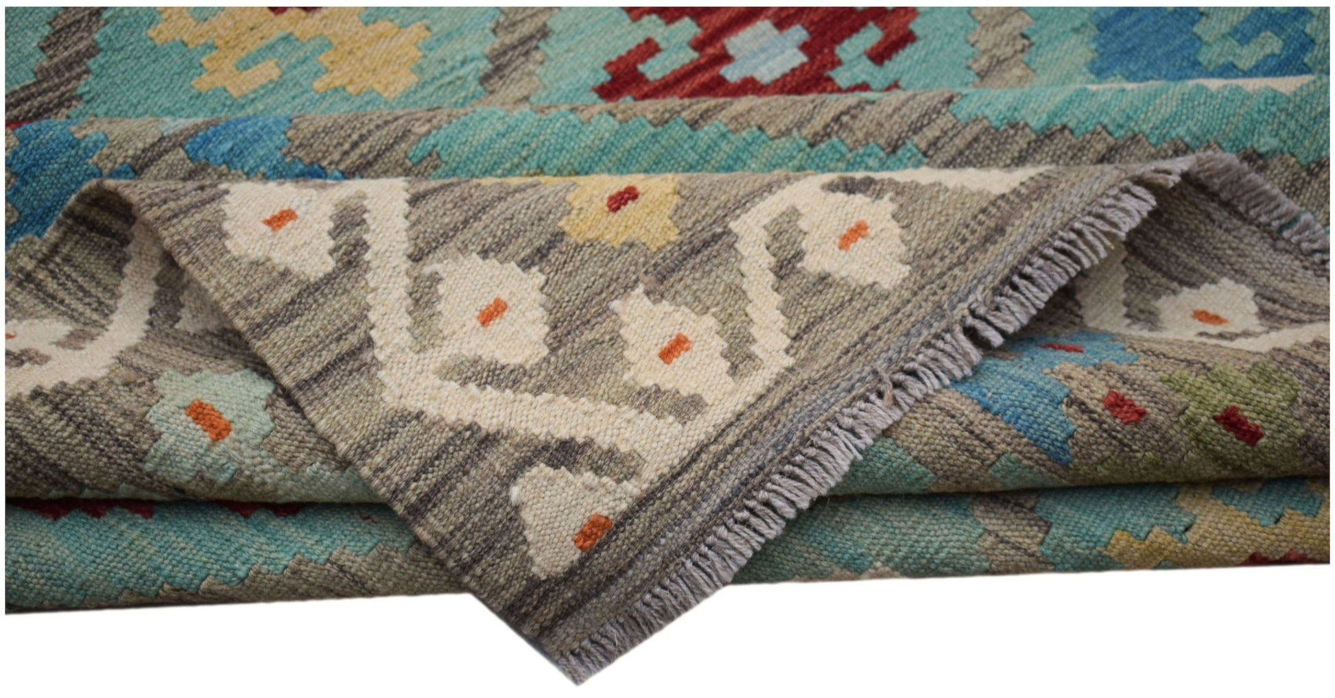 A handmade Afghan Maimana kilim rug featuring geometric patterns in blue, red, and grey wool.