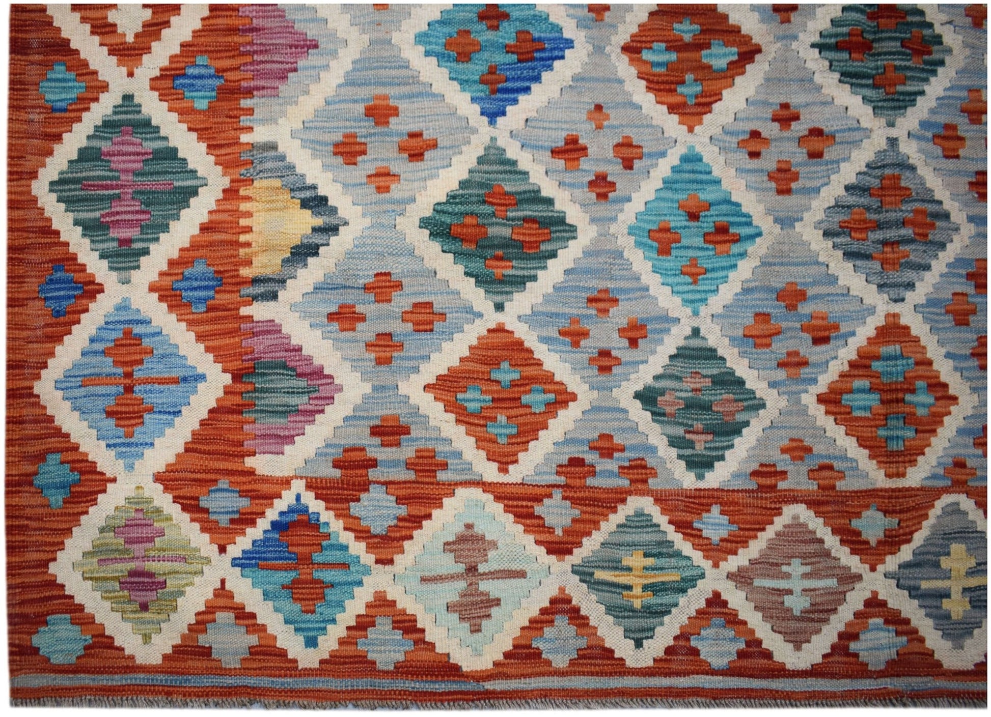 Handwoven Afghan Maimana kilim featuring a vibrant geometric diamond pattern in wool.