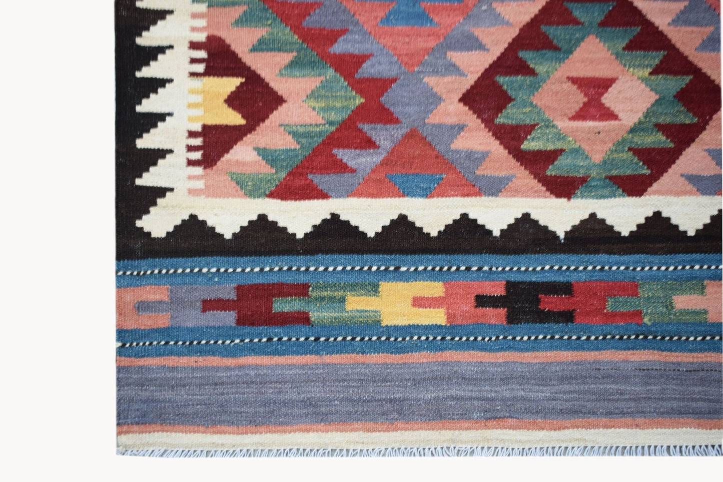 Handwoven Afghan Maimana kilim featuring a geometric pattern in vibrant multicolored wool.