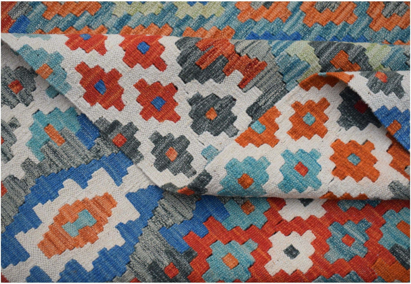 Handwoven Afghan Maimana kilim rug featuring a colorful geometric pattern in wool.