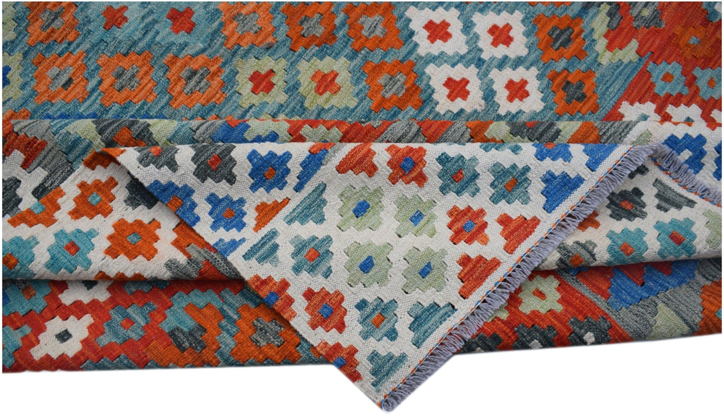 Handwoven Afghan Maimana kilim rug featuring a colorful geometric pattern on a flat wool weave.