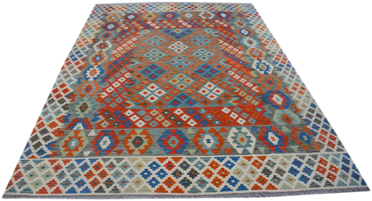 Handwoven Afghan Maimana kilim rug featuring a vibrant geometric pattern in wool.