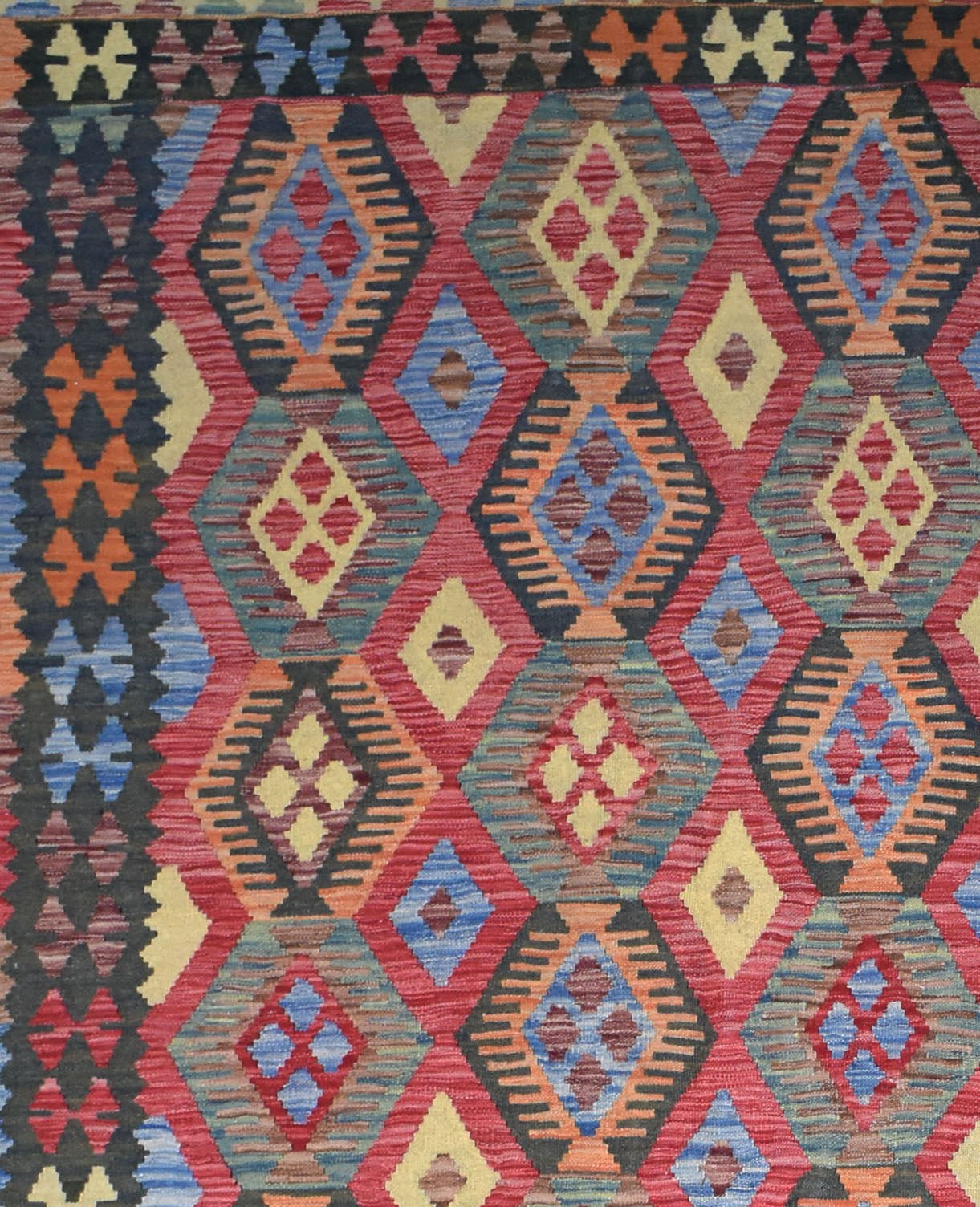 Handmade Afghan Maimana kilim rug featuring a vibrant geometric diamond pattern in wool.