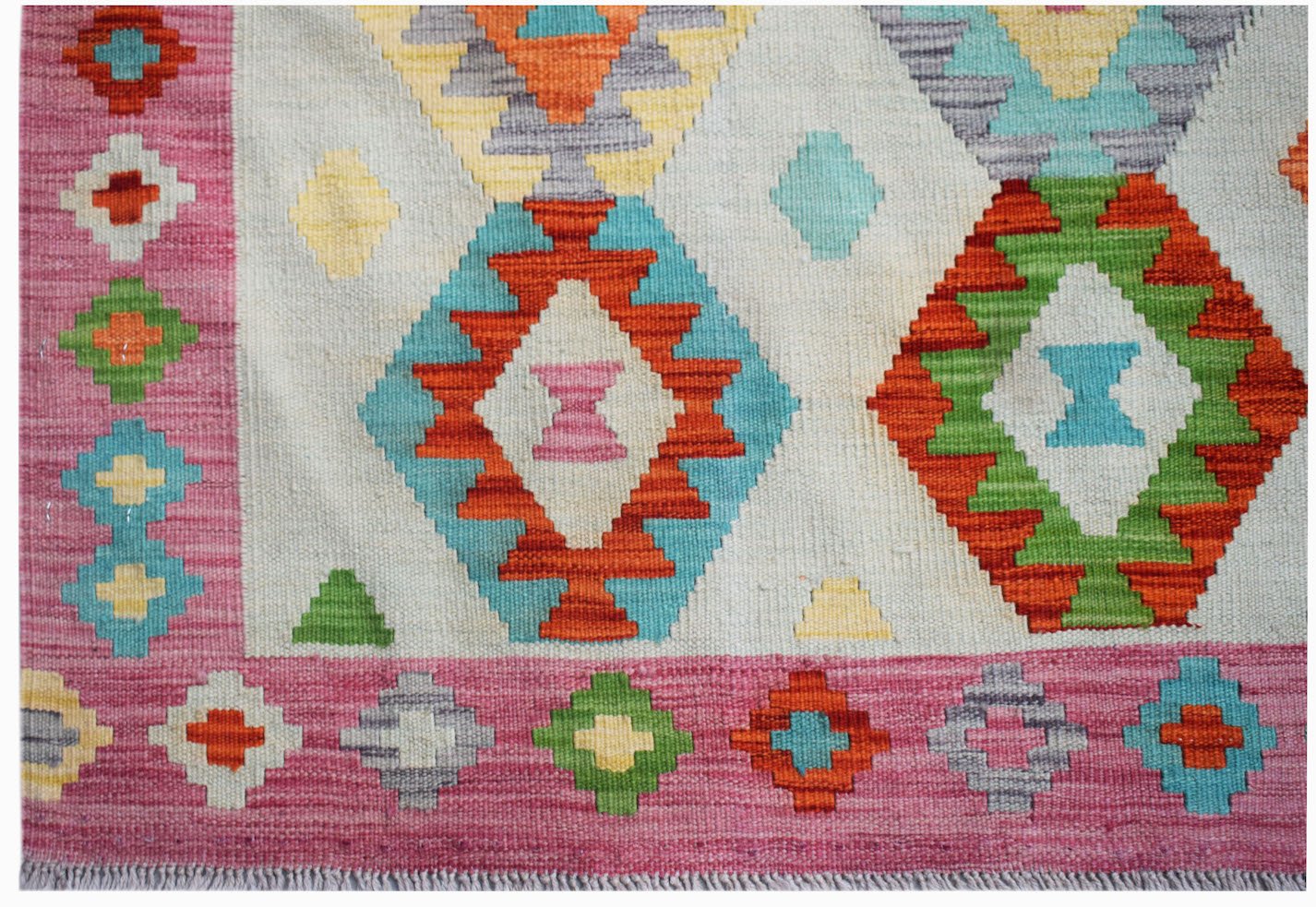 Handwoven Afghan Maimana kilim featuring a geometric diamond pattern in vibrant multicolored wool.