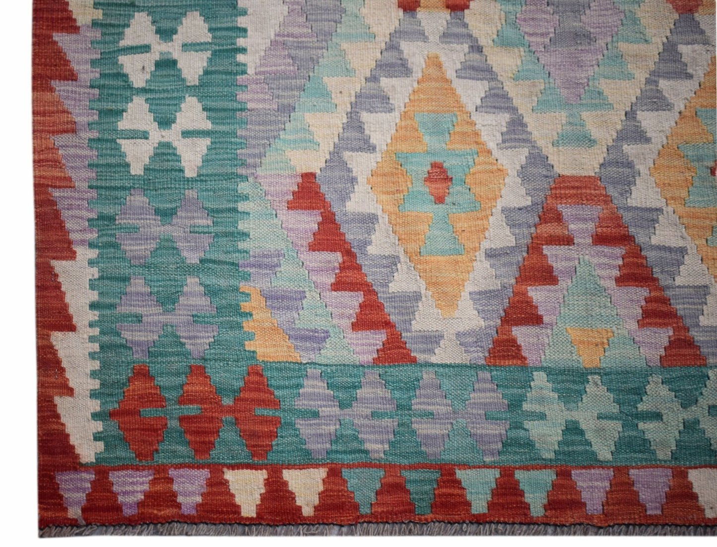 Handwoven Afghan Maimana kilim featuring a geometric diamond pattern in vibrant multicolored wool.