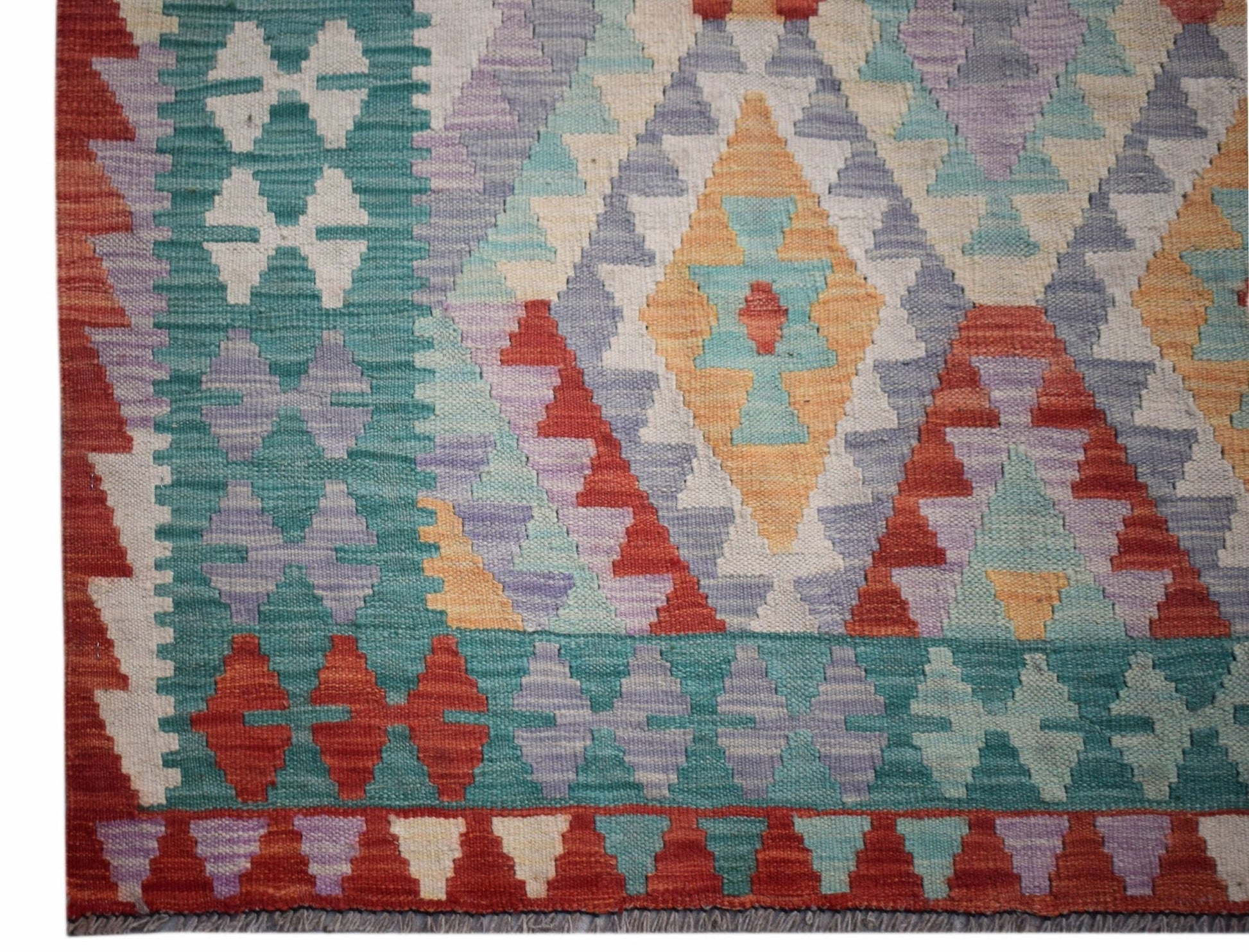 Handwoven Afghan Maimana kilim featuring a geometric diamond pattern in vibrant multicolored wool.