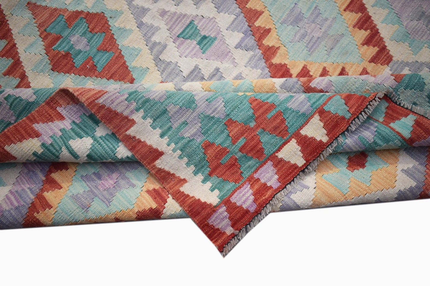 Handwoven Afghan Maimana kilim rug featuring a colorful geometric diamond pattern.